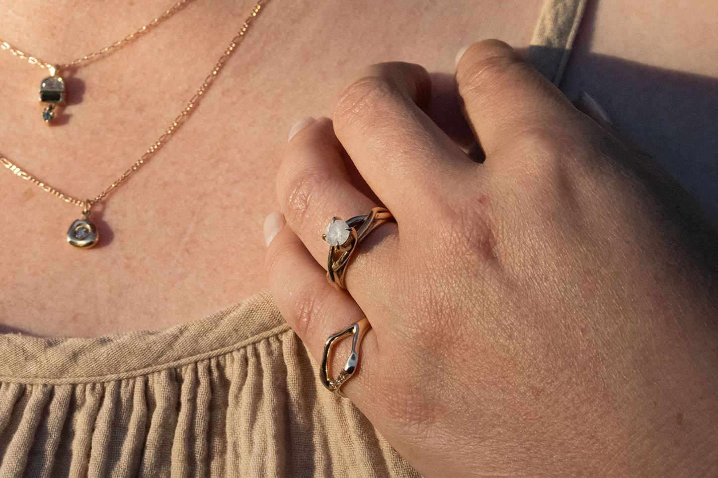 Model wears Twist Solitaire Ring in 14k yellow gold and Split Root Ring in 14k yellow gold By Kestrel Dillon Model wears Twist Solitaire Ring in 14k yellow gold and Split Root Ring in 14k yellow gold By Kestrel Dillon