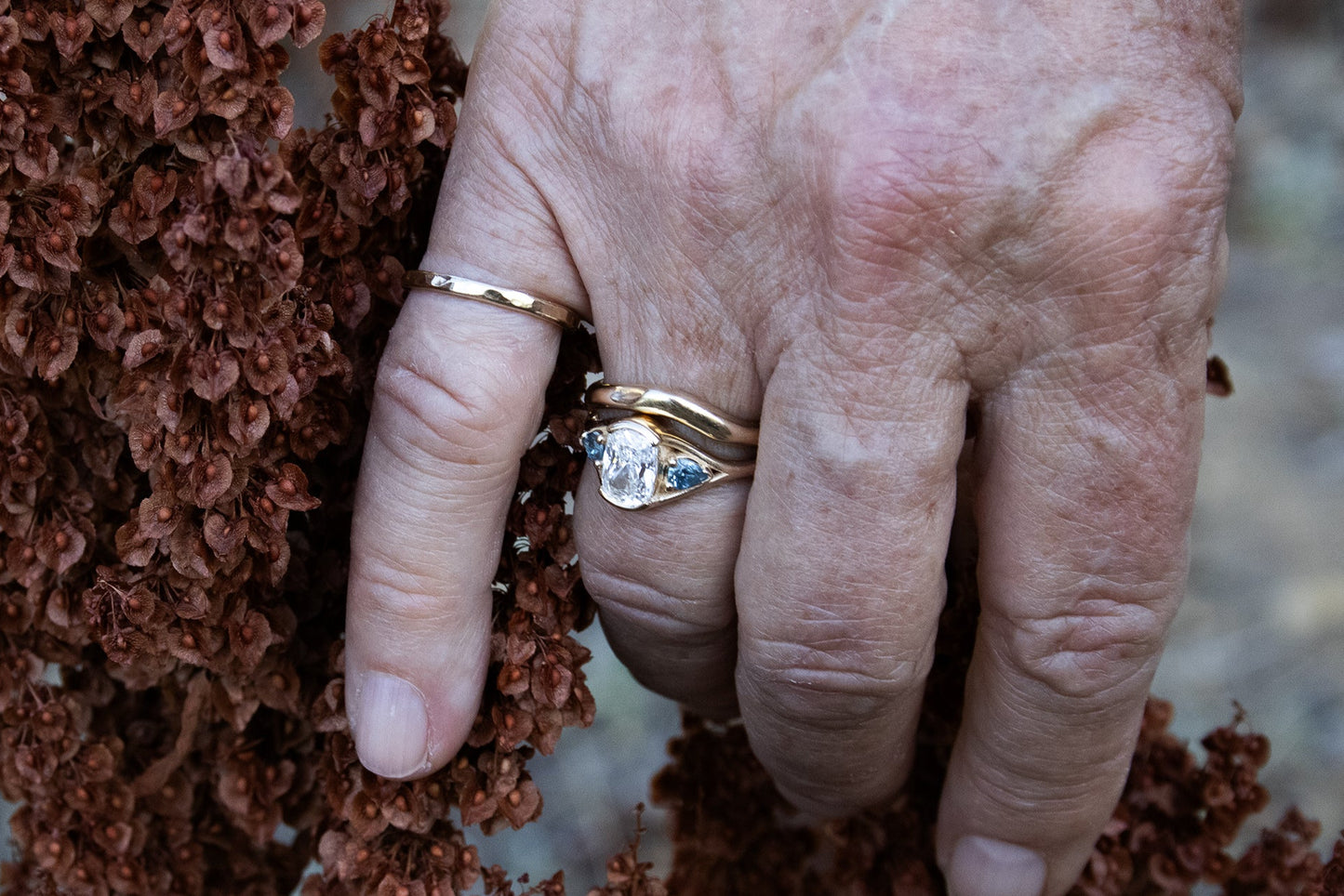 Model wears Triple Tributary Ring and Root Curve Diamond Band in 14k yellow gold by Kestrel Dillon Model wears Triple Tributary Ring and Root Curve Diamond Band in 14k yellow gold by Kestrel Dillon