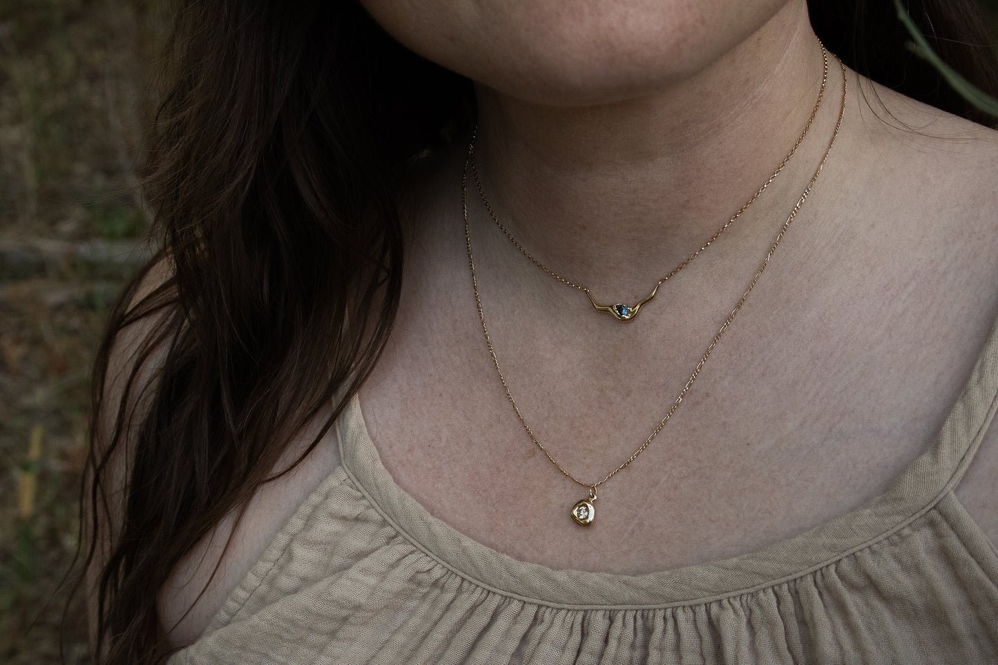 Model wears Pear Dip Necklace in 14k yellow gold and Star Jelly Pendant with Champagne Diamond by Kestrel Dillon Model wears Pear Dip Necklace in 14k yellow gold and Star Jelly Pendant with Champagne Diamond by Kestrel Dillon