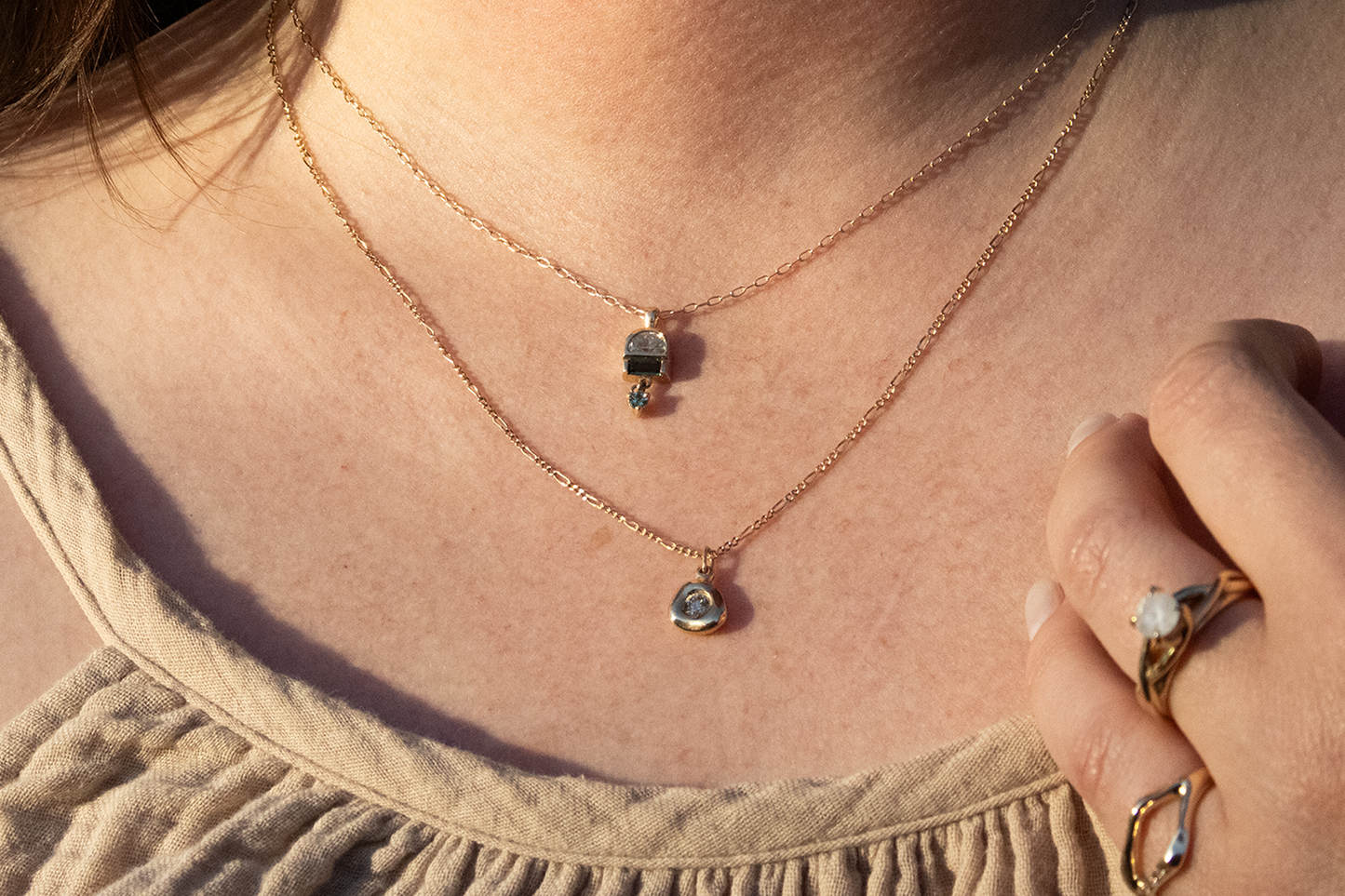 Model wears Monsoon Pendant and Star Jelly Pendant with Champagne Diamond in 14k yellow gold by Kestrel Dillon Model wears Monsoon Pendant and Star Jelly Pendant with Champagne Diamond in 14k yellow gold by Kestrel Dillon