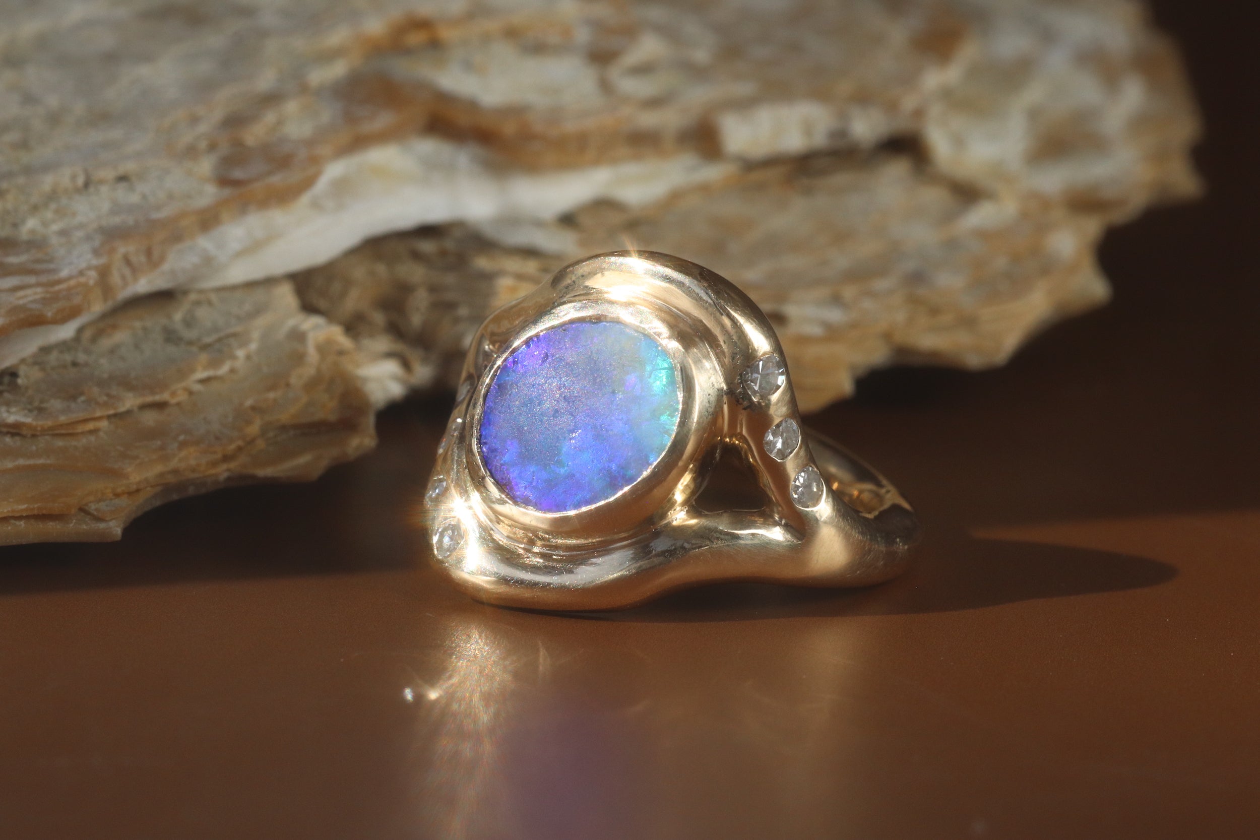 custom ring by Kestrel Dillon featuring an opal with side white diamonds