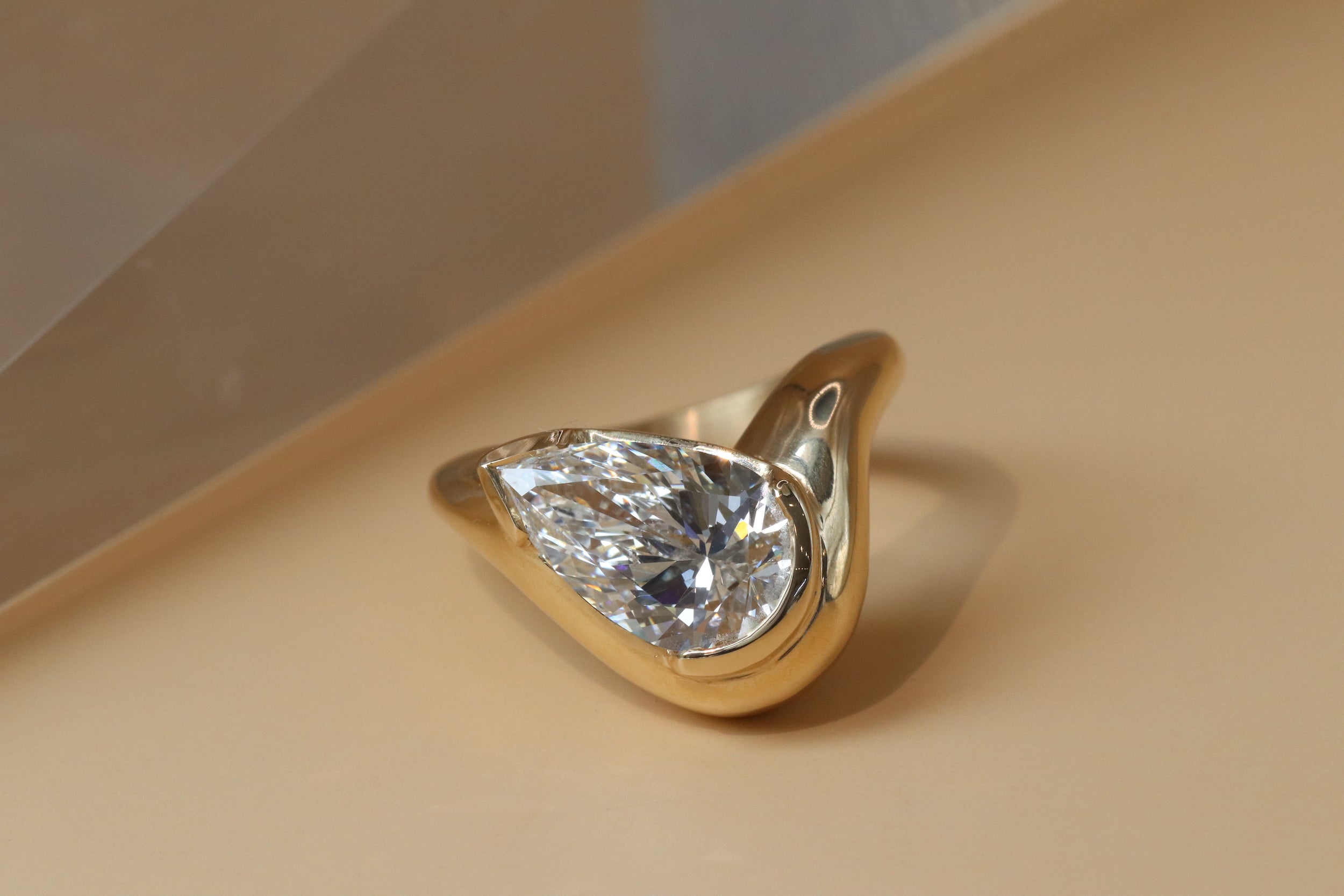 custom engagement ring by Kestrel Dillon featuring large pear shaped white diamond