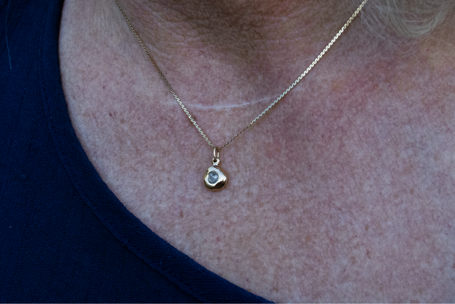 Model wears Star Jelly Pendant with Rose Cut Diamond in 14k yellow gold by Kestrel Dillon
